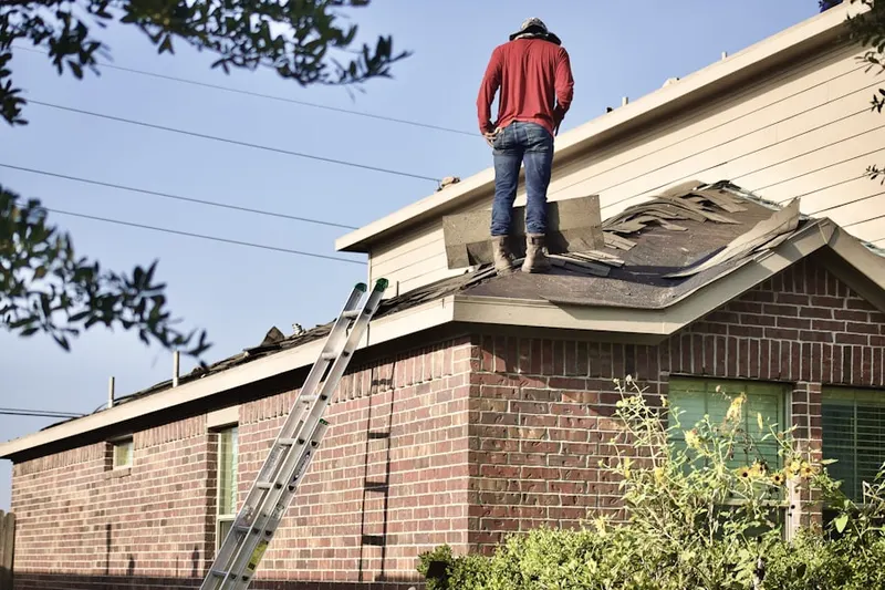 Professional roofer working on a residential roof in Cedar Knolls
